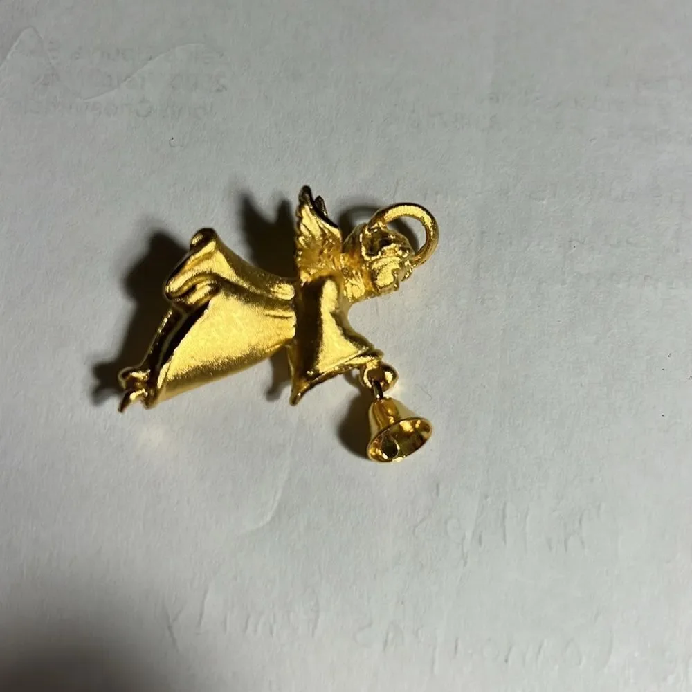 Faux gold angel with bell pin.